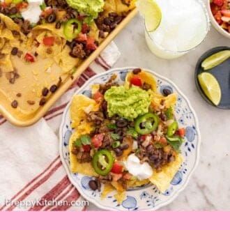 Pinterest graphic of an overhead view of a plate of nachos beside a sheet pan of more nachos.