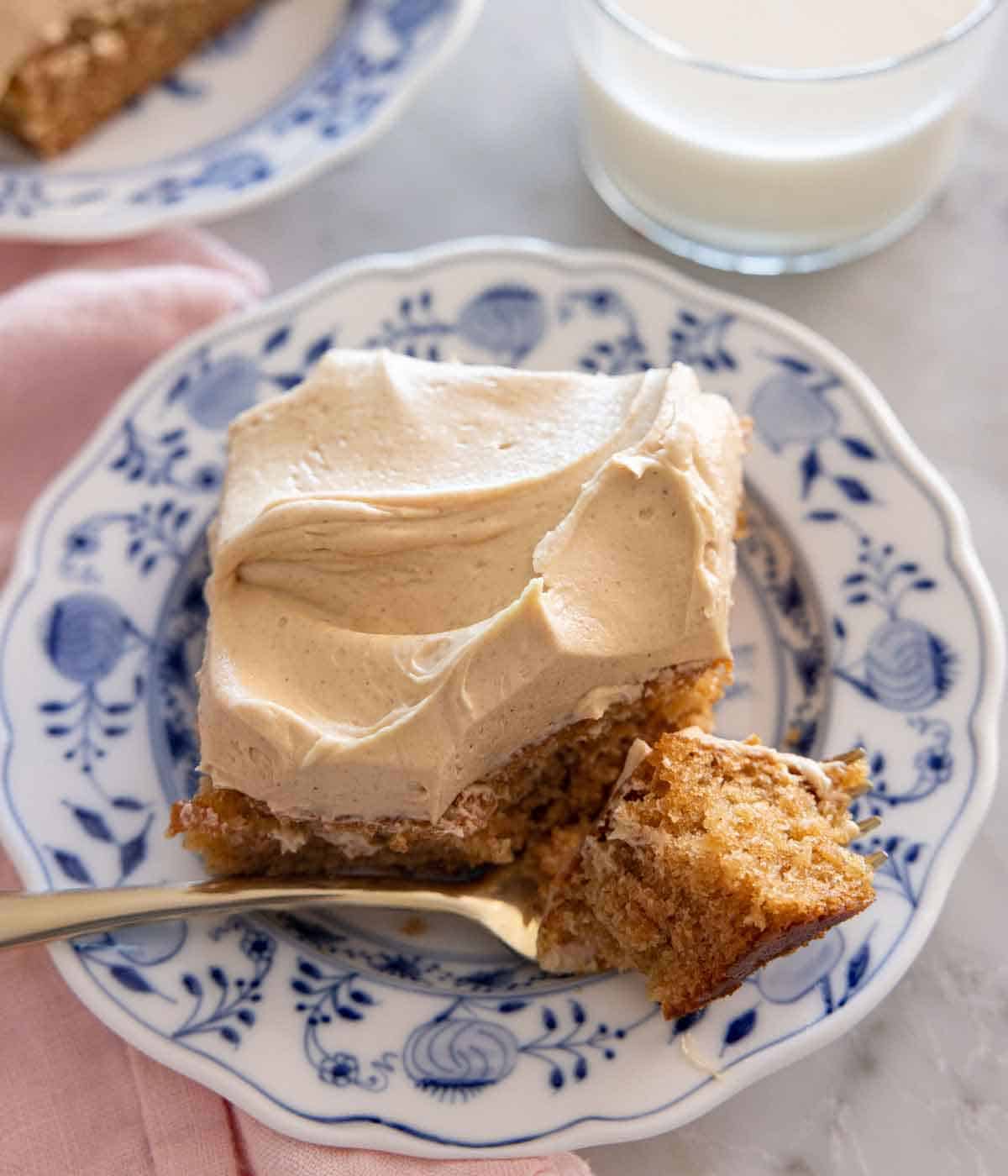 A plate of peanut butter cake with a bite on a fork.