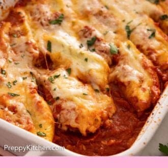Pinterest graphic of a close view of stuffed shells in a baking dish.