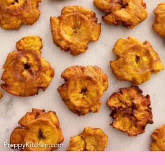 Pinterest graphic of tostones in a single layer on a marble surface.