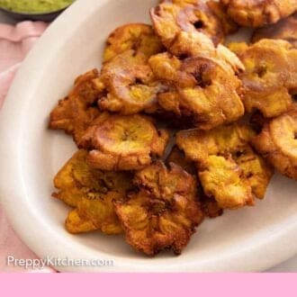 Pinterest graphic of an oval platter of tostones.