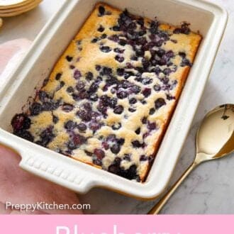 Pinterest graphic of a baking dish of blueberry cobbler with fresh blueberries scattered around.