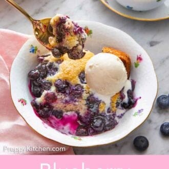 Pinterest graphic of a spoonful of blueberry cobbler lifted from a bowl with cobbler and ice cream.
