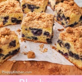 Pinterest graphic of blueberry coffee cake cut into square pieces on a cutting board.