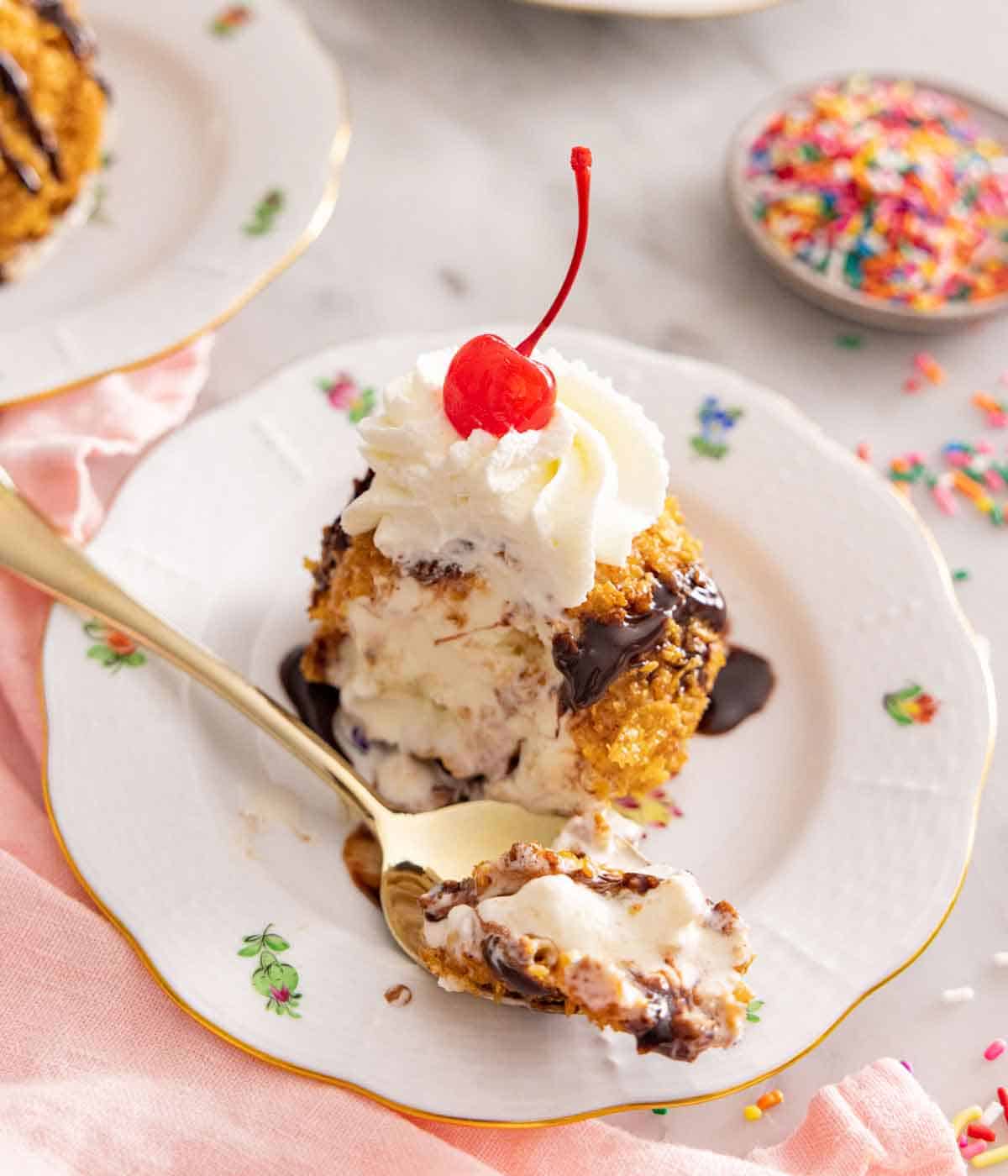 A plate with fried ice cream with a spoonful spooned out.
