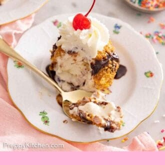 Pinterest graphic of a spoonful of fried ice cream on a plate with the rest of the dessert.