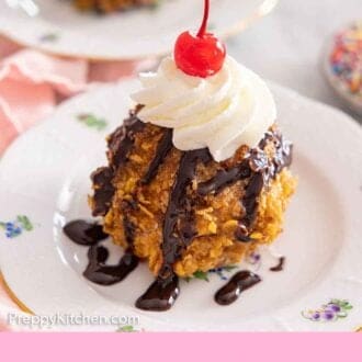 Pinterest graphic of a plate of fried ice cream with whipped cream, chocolate sauce, and a cherry on top.