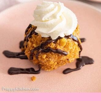 Pinterest graphic of a fried ice cream ball with chocolate and whipped cream on top.