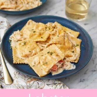 Pinterest graphic of a plate of lobster ravioli by a glass of wine.