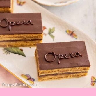 Pinterest graphic of a platter with multiple opera cake pieces with "opera" written on them.