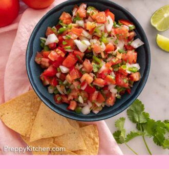 Pinterest graphic of an overhead view of a bowl of pico de gallo with chips and other ingredients around the bowl.