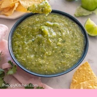 Pinterest graphic of salsa verde in a bowl with a chip dipped it it and lifted.
