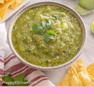 Pinterest graphic of a bowl of salsa verde with cilantro on top with ingredients scattered around it.