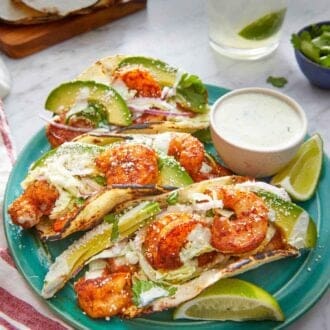 Pinterest graphic of a plate of three shrimp tacos with a dip on the side.