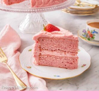Pinterest graphic of a slice of strawberry cake on a plate in front of a cake stand with the rest of the cake.