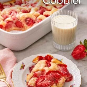 Pinterest graphic of a plate with a serving of strawberry cobbler in front of a glass of milk and baking dish.