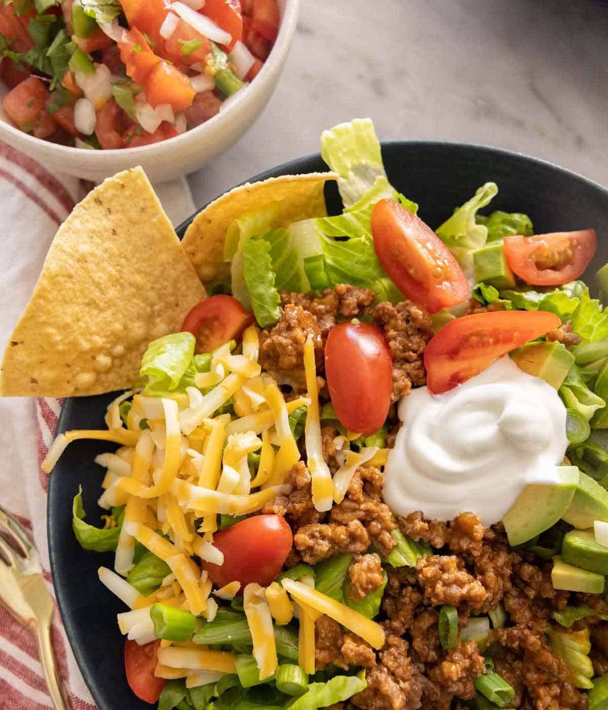 Close up of a taco salad bowl with tortilla chips.