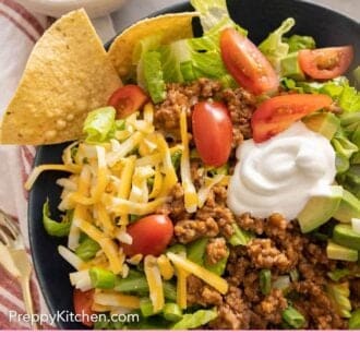 Pinterest graphic of a close up taco salad with tortilla chips.