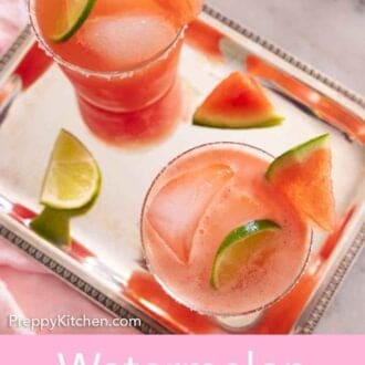 Pinterest graphic of an overhead view of two glasses of watermelon margaritas on a sliver tray.