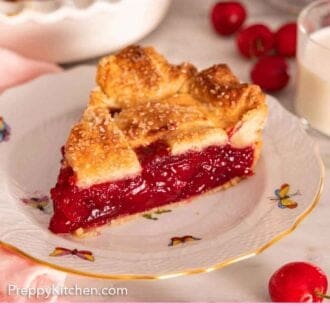 Pinterest graphic of a plate of cherry pie with a crispy golden crust with fresh cherries scattered around.