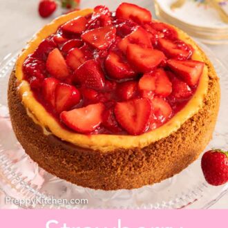 Pinterest graphic of a strawberry cheesecake with a pile of cut strawberries on top.