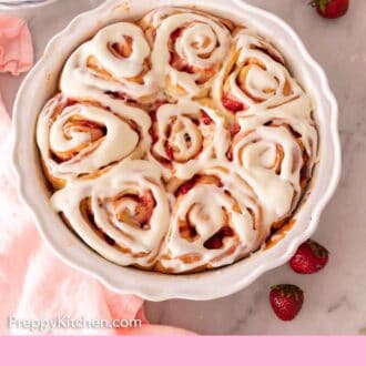 Pinterest graphic of an overhead view of strawberry rolls in a baking dish with cream cheese icing on top.
