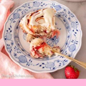 Pinterest graphic of a strawberry roll on a plate with a bite missing and a forkful of the roll beside it.