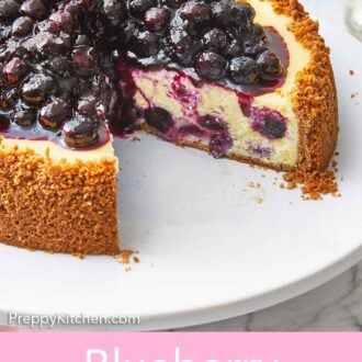 Pinterest graphic of a close view of a blueberry cheesecake with a slice cut, showing the blueberries baked into the cheesecake.