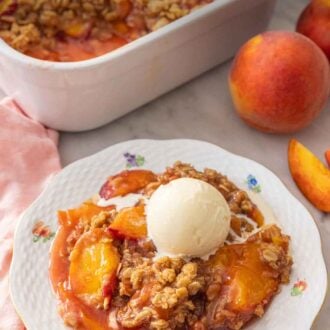 Pinterest graphic of a plate of peach crisp with a scoop of vanilla ice cream on top by a baking dish.