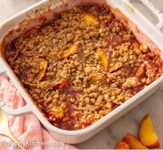 Pinterest graphic of peach crisp in a white baking dish with cut peaches scattered around.