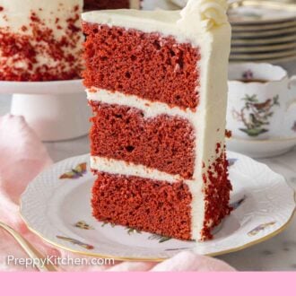 Pinterest graphic of a slice of red velvet cake standing up on a plate, showing the three layers with frosting between each layer.