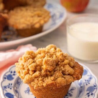 Pinterest graphic of an apple muffin on a plate with a glass of milk behind it along with a platter.