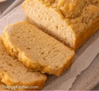 Pinterest graphic of a close view of a loaf of beer bread, sliced open to show the crumb.