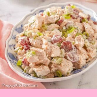 Pinterest graphic of a platter of chicken salad with a drink in the background along with another serving on a plate.