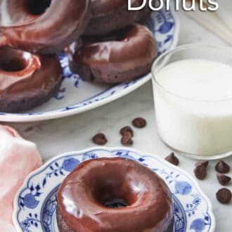 Pinterest graphic of a plate with a chocolate donut in front of a glass of milk and more donuts.