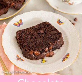 Pinterest graphic of a plate with a slice of chocolate zucchini bread with tea beside it.