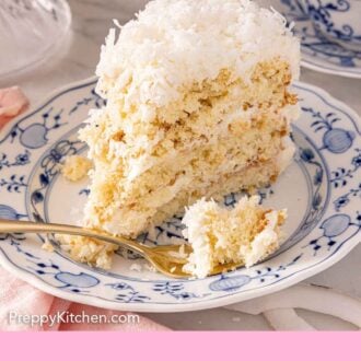 Pinterest graphic of a slice of coconut cake with a fork resting in front of a piece of cake on it.