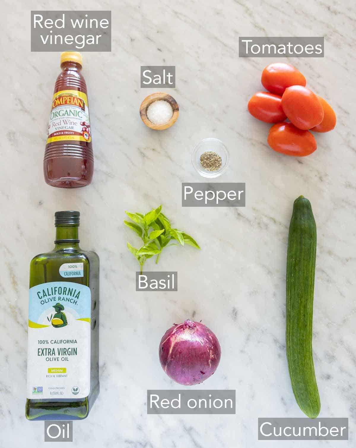 Ingredients needed to make cucumber tomato salad.