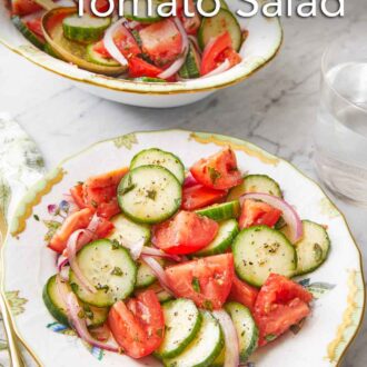 Pinterest graphic of a plate of cucumber tomato salad with a platter in the background.