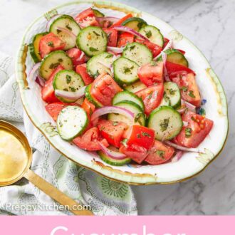 Pinterest graphic of an oval platter of cucumber tomato salad with a stack of plates in the back.