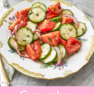 Pinterest graphic of a plate of cucumber tomato salad with a glass of water and another bowl behind it.