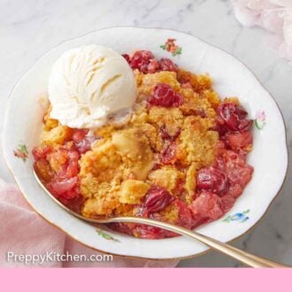 Pinterest graphic of a bowl with dump cake in it along with a spoon and a scoop of ice cream.