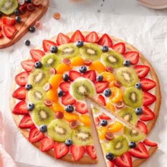Pinterest graphic of a fruit pizza with a slice cut and pulled away from the pizza.