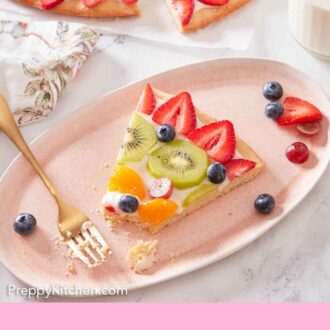 Pinterest graphic of a pink plate with a slice of fruit pizza with a fork and a bite taken out of the slice.