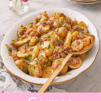 Pinterest graphic of a platter of German potato salad with a serving spoon tucked into it.