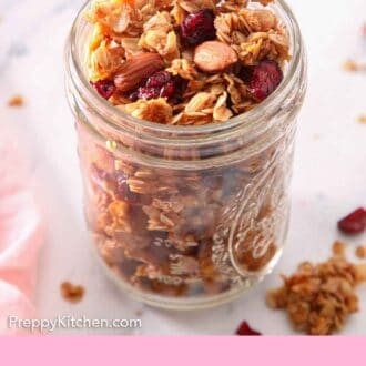 Pinterest graphic of a mason jar full of granola with some scattered on the side.