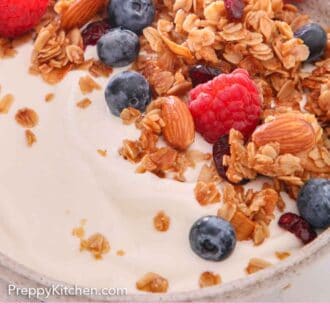 Pinterest graphic of a close view of granola over yogurt with some fresh berries.