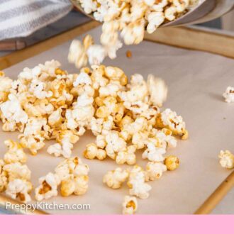 Pinterest graphic of kettle corn poured into a lined sheet pan.