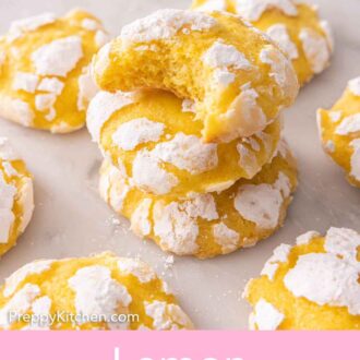 Pinterest graphic of a stack of three lemon crinkle cookies with a bite taken out of the top cookie.