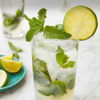 Pinterest graphic of a glass of mojito with a slice of lime and fresh mint as garnish.
